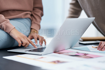 Buy stock photo Shot of an unrecognisable man and woman using a laptop while working from home