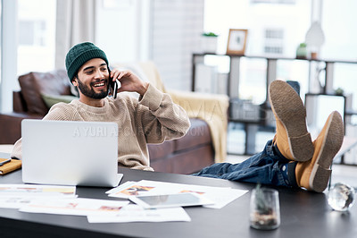 Buy stock photo Shot of a confident young man using a smartphone while working from home
