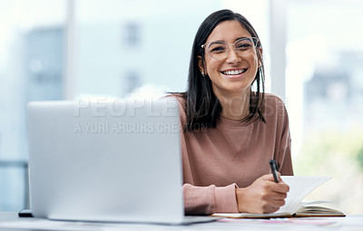 Buy stock photo Shot of a confident young woman using a laptop while working from home