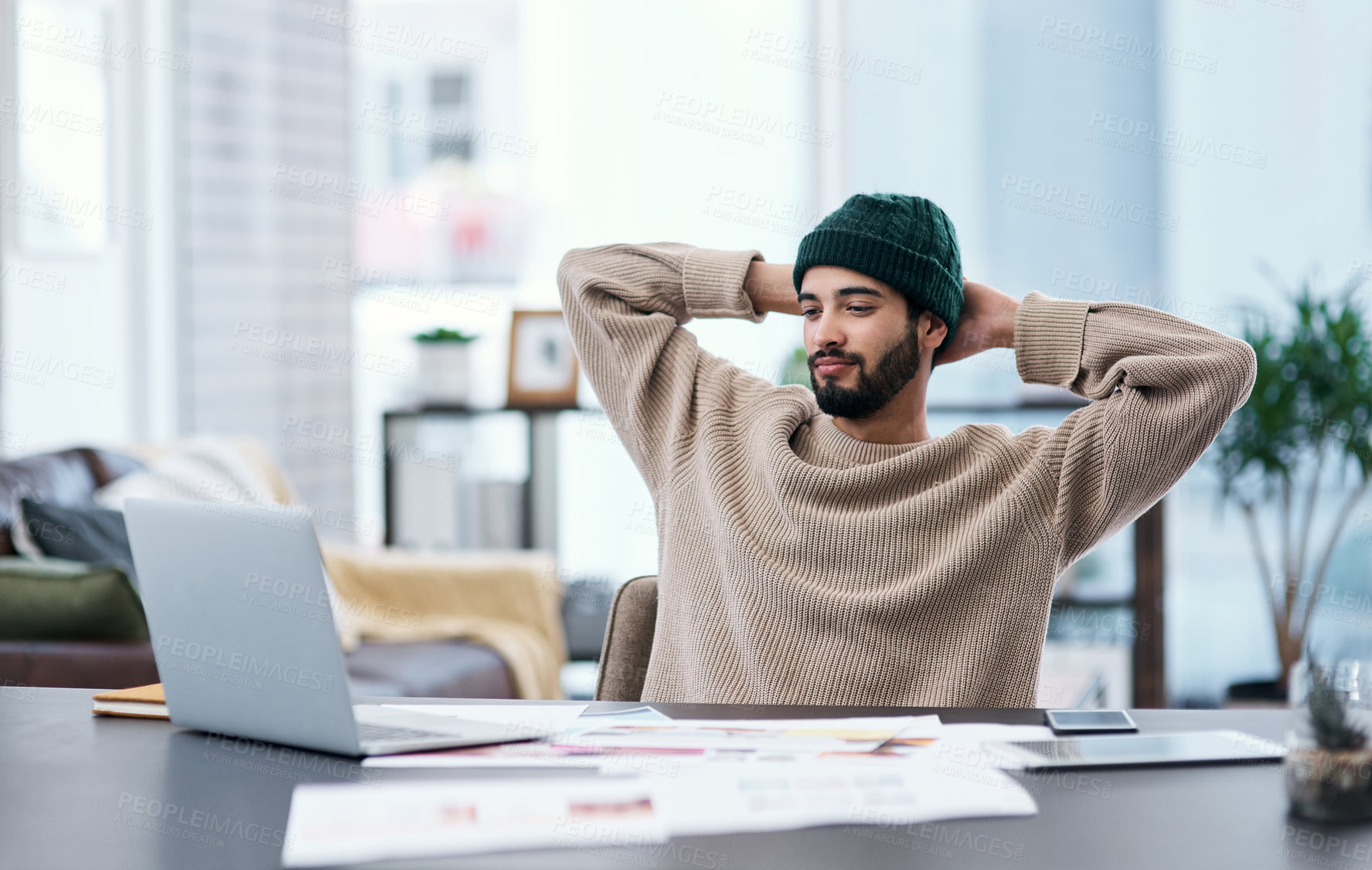 Buy stock photo Shot of a young man taking a break while working from home