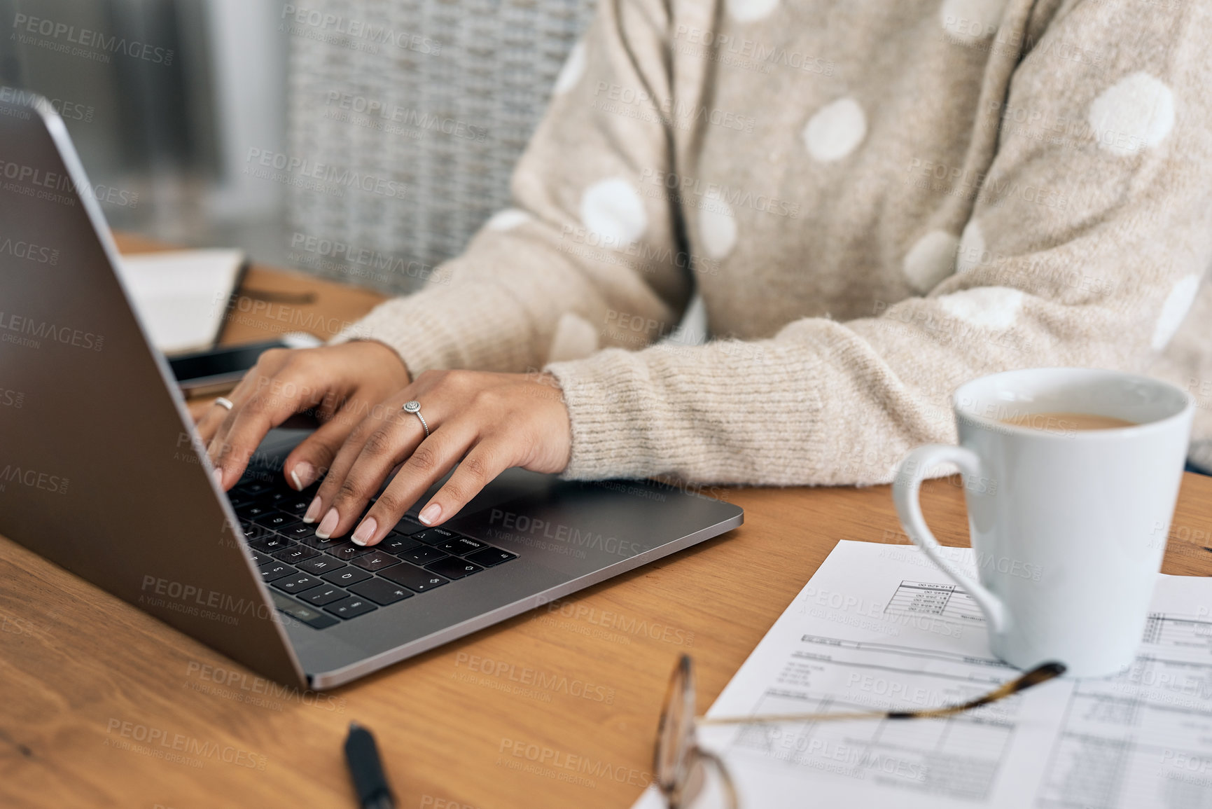 Buy stock photo Cropped shot of a woman using her laptop while working from home