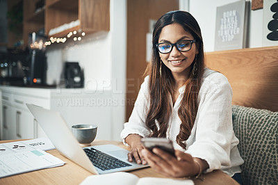 Buy stock photo Shot of an entrepreneur using her cellphone and laptop while working from a cafe