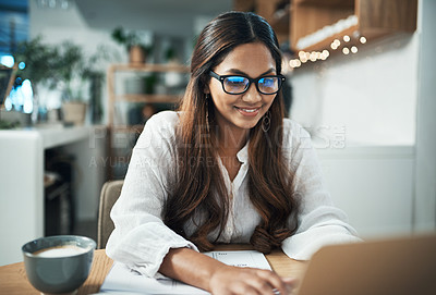 Buy stock photo Shot of a businesswoman using her laptop while working at a cafe
