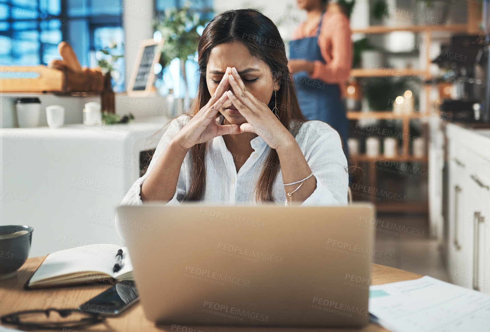 Buy stock photo Shot of a woman looking stressed while working from a cafe