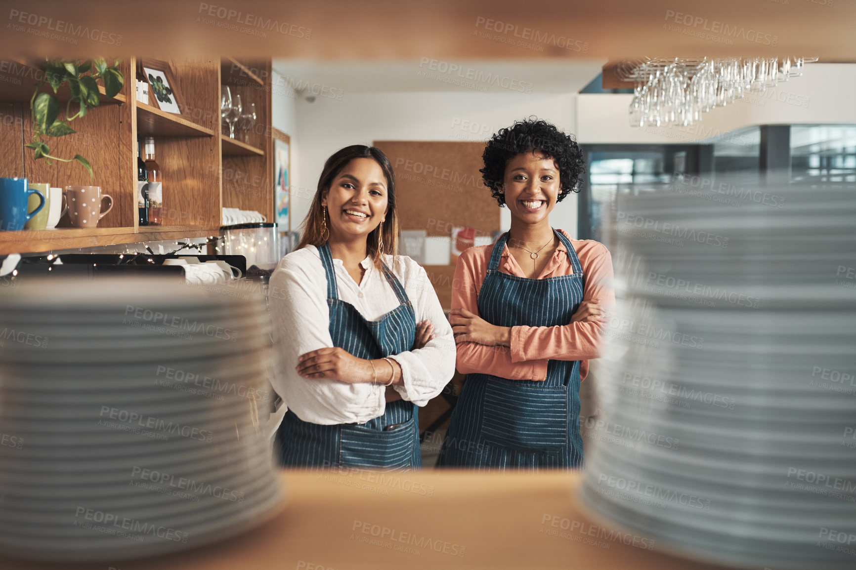 Buy stock photo Cropped shot of two young women working in a cafe