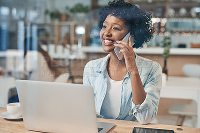 Buy stock photo Shot of a businesswoman talking on her cellphone while working from a cafe