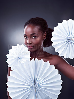Buy stock photo Black woman, portrait and origami fans in studio for beauty, makeup and cosmetics by dark background. African female person, face and oriental art on backdrop for creativity, foundation and glow