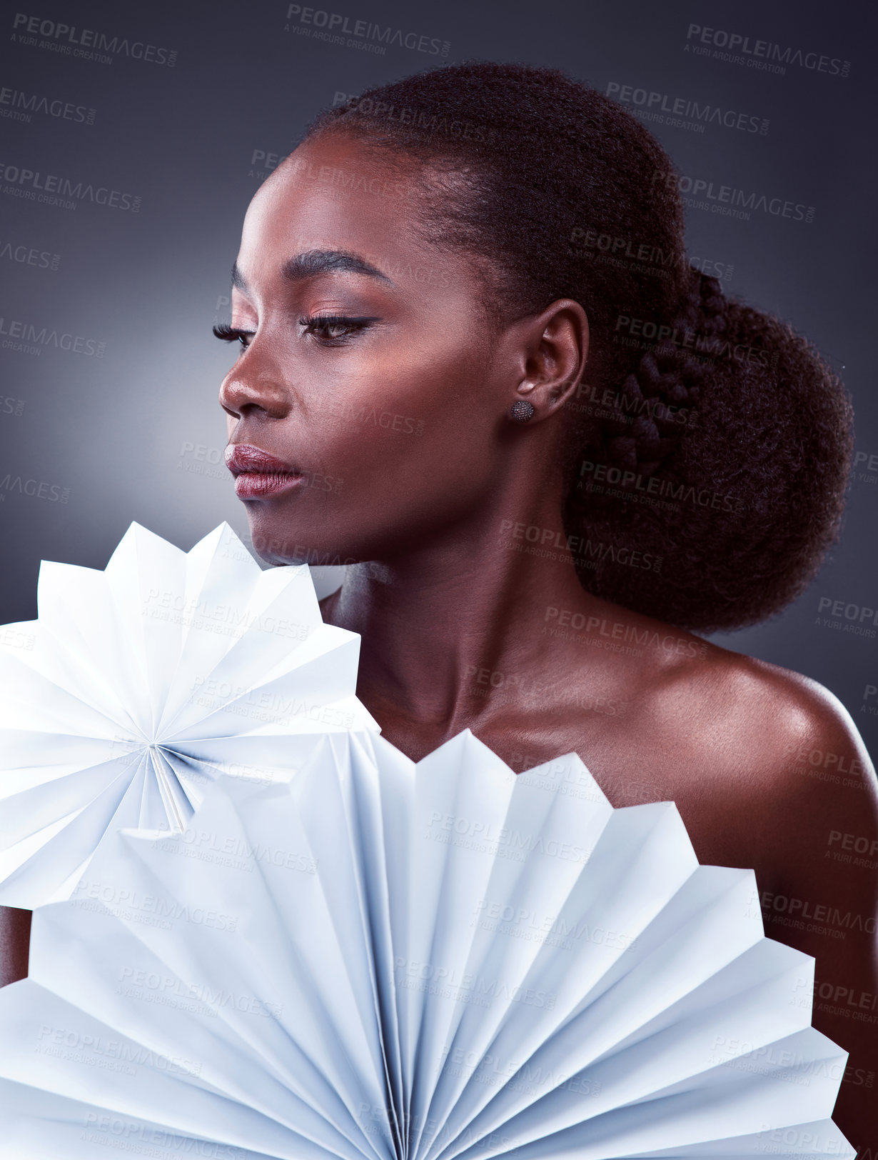 Buy stock photo Fashion, thinking and black woman with origami fans in studio, beauty and dark background. Thought, female person or model with traditional craft paper or art for elegant, and creative design