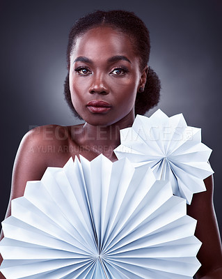 Buy stock photo Black woman, portrait and origami fans in studio, cosmetics and oriental beauty on dark background. Female person, skin treatment and confidence for glow, serious and foundation shine for dermatology