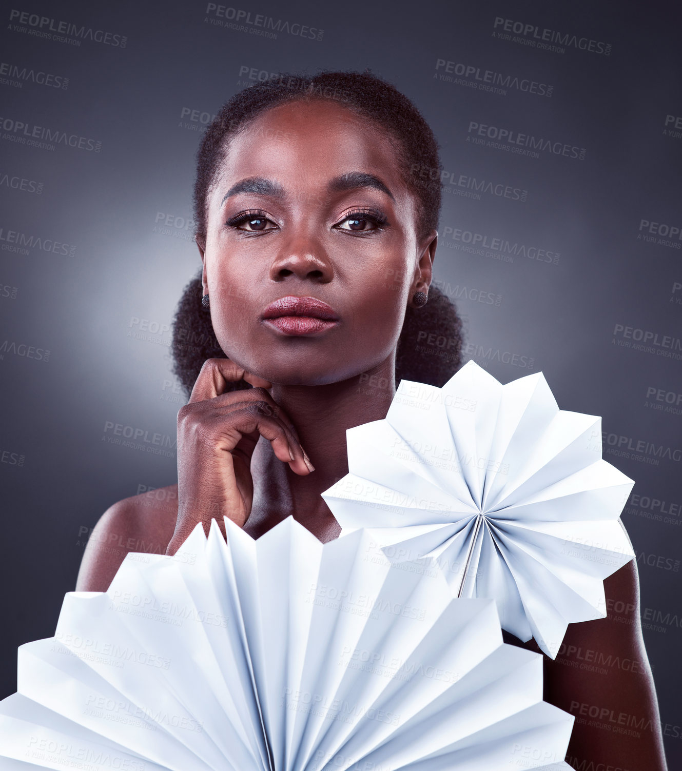 Buy stock photo Black woman, portrait and origami fans for beauty, cosmetics and oriental on studio background. Female person, skin treatment and confidence for glow, serious and foundation shine for dermatology