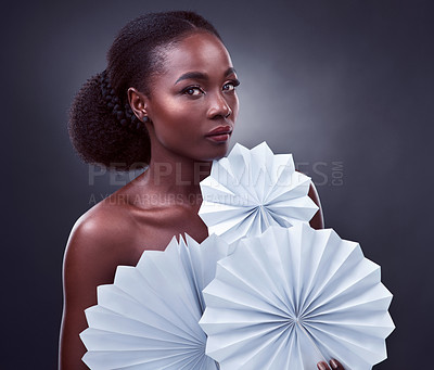 Buy stock photo Portrait, black woman and origami in studio with makeup for beauty, cosmetics and elegance on dark background. Female person, confidence and paper fan with fashion or style, creativity and art