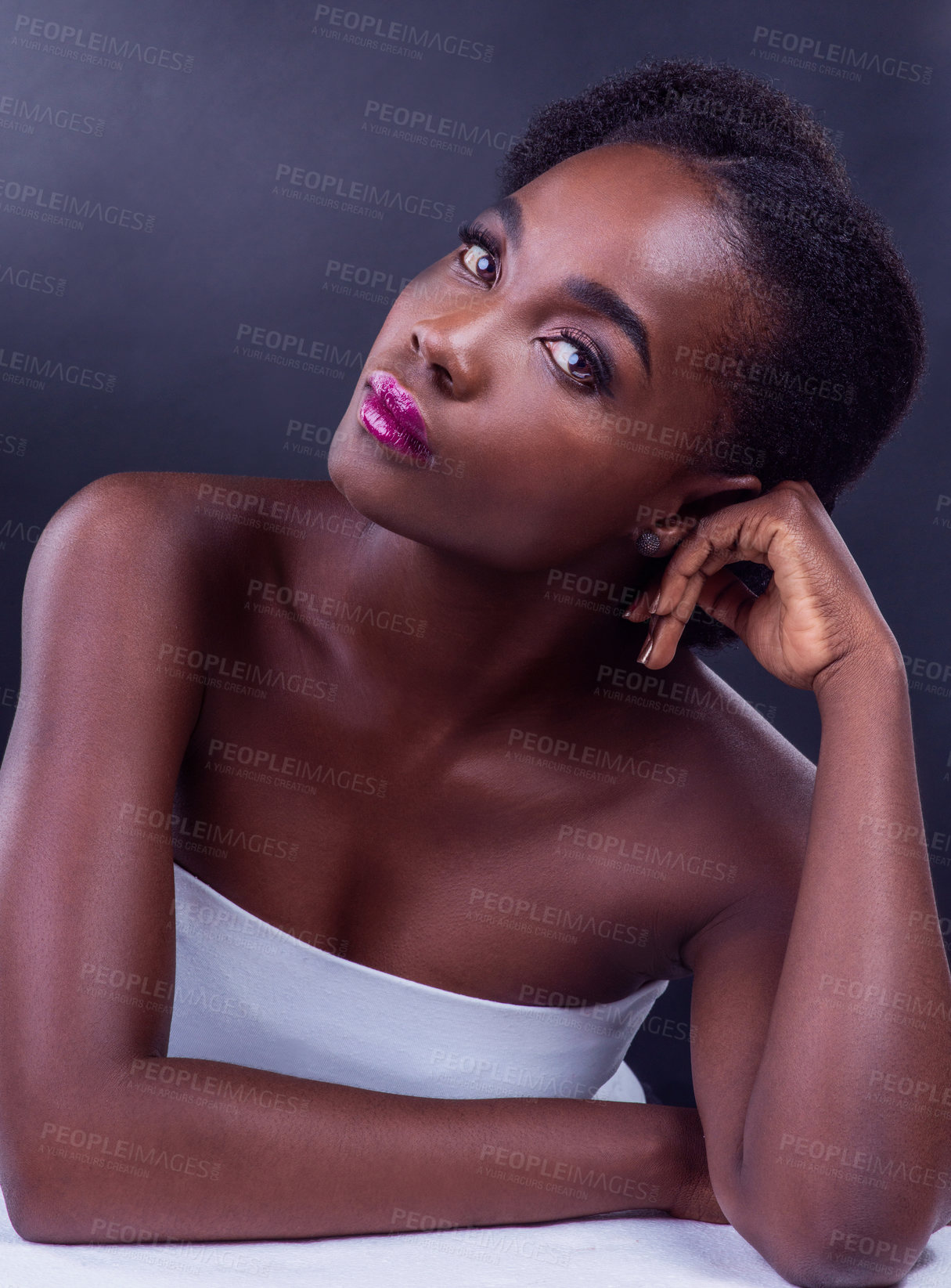 Buy stock photo Studio portrait of a beautiful young woman posing against a black background