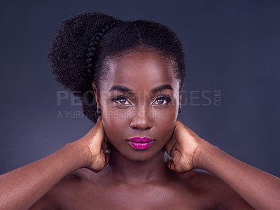 Buy stock photo Studio portrait of a beautiful young woman posing against a black background