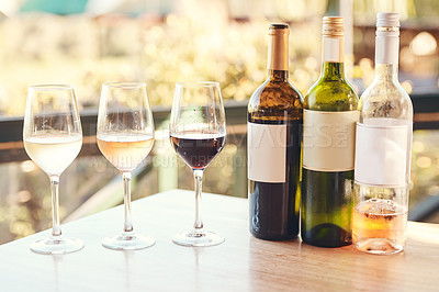 Buy stock photo Cropped shot of various wines lined up on a table for an outdoors wine tasting