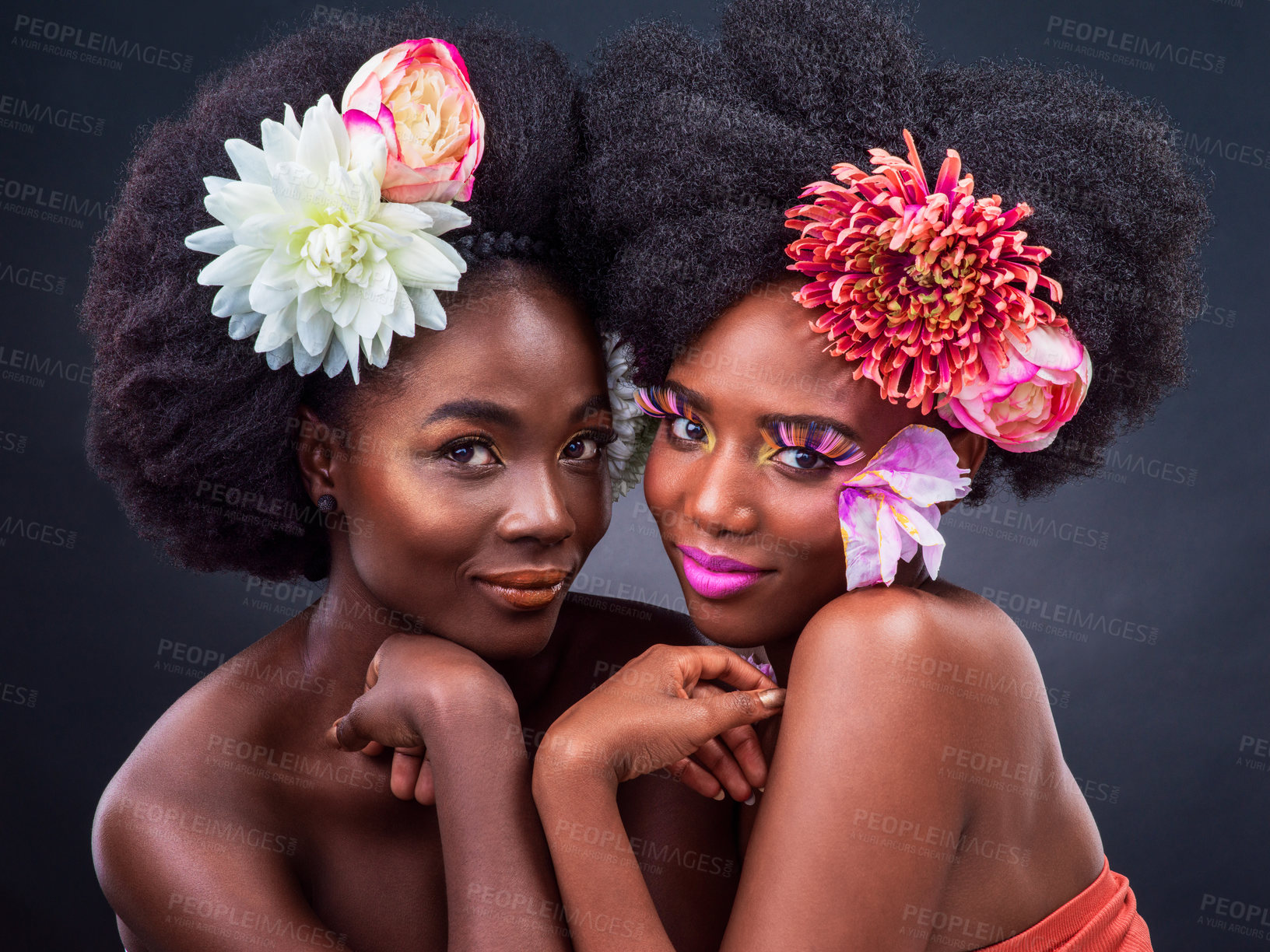 Buy stock photo Spring flowers, portrait and black women with makeup on dark background for organic cosmetics, makeover or skin glow in studio. Beauty, afro and models with plant for aesthetic, eyelashes or lipstick