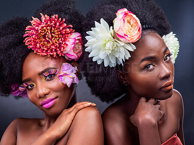 Buy stock photo African, beauty and confident with flowers in makeup and art in dark background, studio and mockup. Floral, cosmetics and friends in portrait with spring creativity or natural black woman in skincare