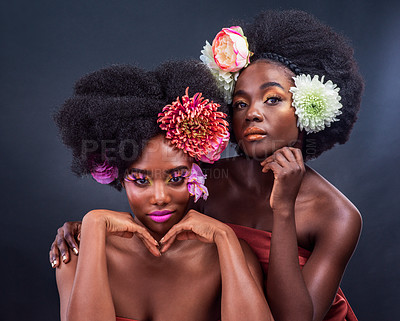 Buy stock photo Beauty, flowers and black women with skincare, art and eco friendly cosmetics in studio for spring. Natural, afro and creative friends on dark background with healthy, organic or sustainable makeup