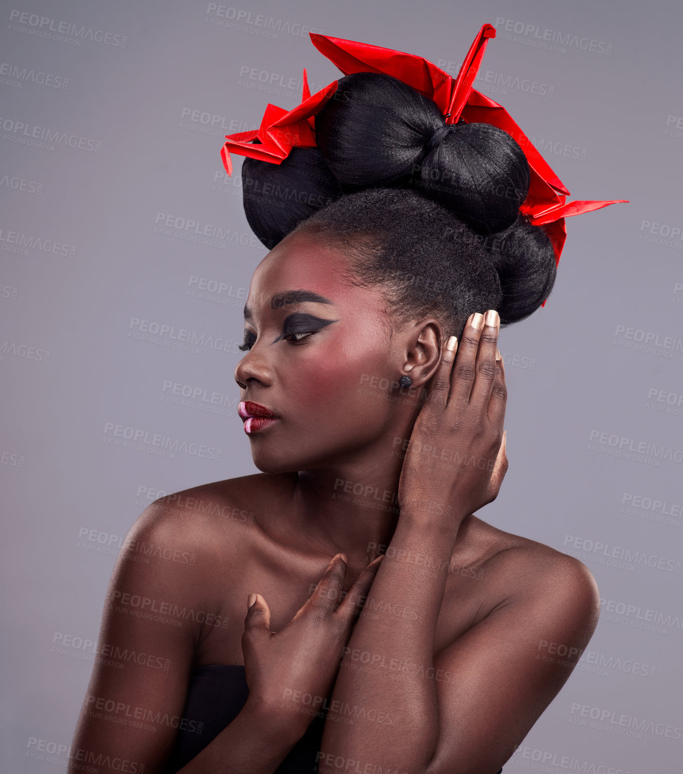 Buy stock photo Woman, beauty and origami in studio for cosmetics with red color, Oriental culture and paper bird. African model, bold makeup and grey background for art deco, confidence and creativity with design