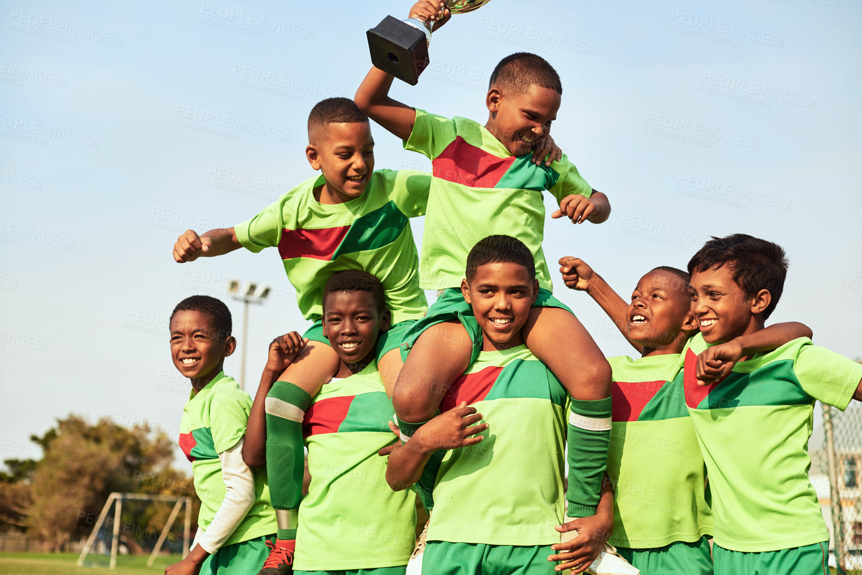 Buy stock photo Shot of a boys soccer team celebrating their victory on a sports field