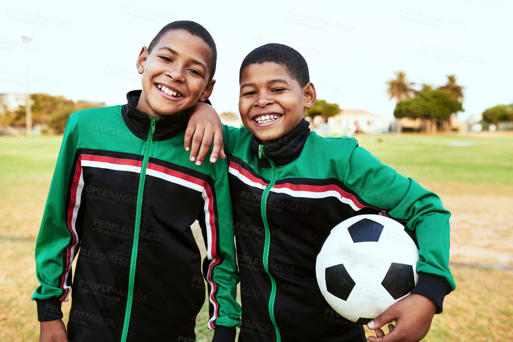 Buy stock photo Portrait of two young boys playing soccer on a sports field
