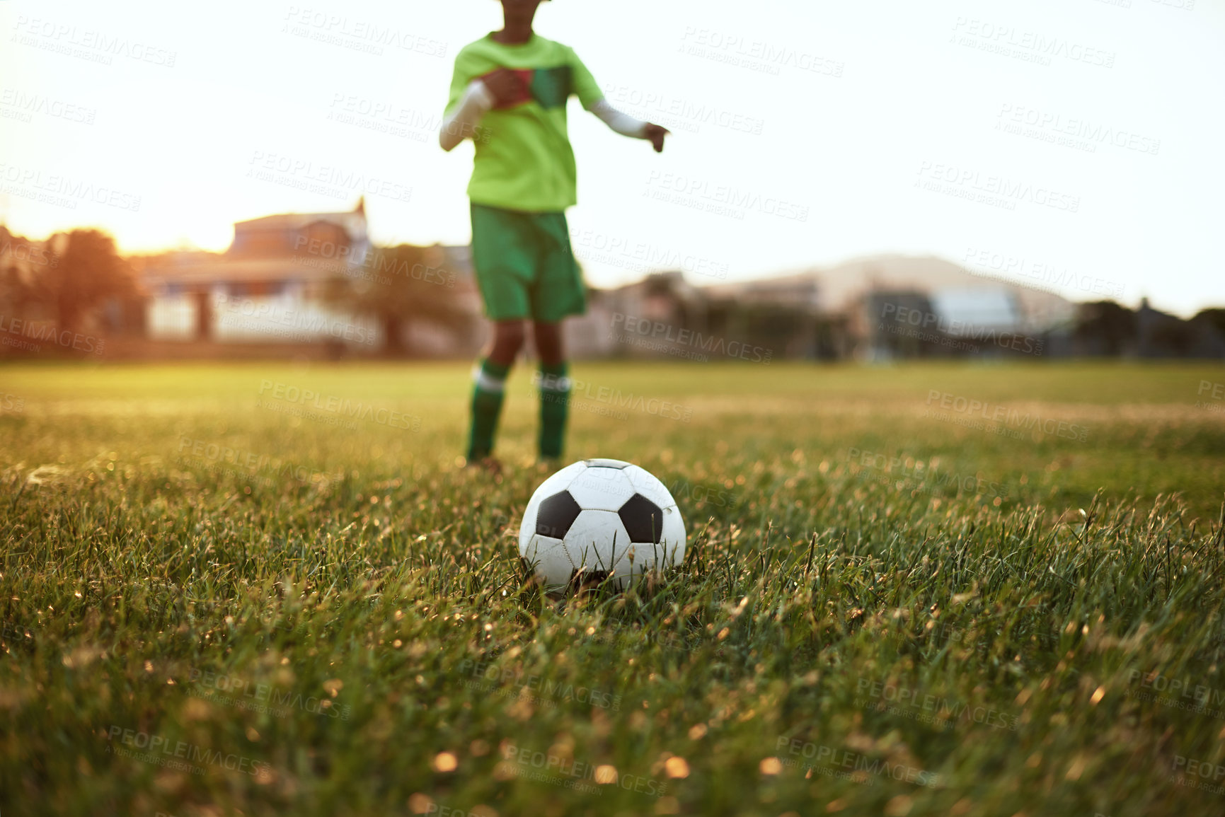 Buy stock photo Closeup shot of a young boy playing soccer on a sports field