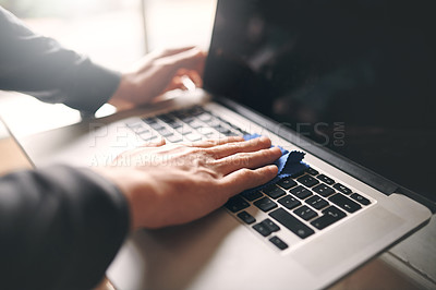 Buy stock photo Cropped shot of an unrecognisable man wiping a laptop with a cloth at home