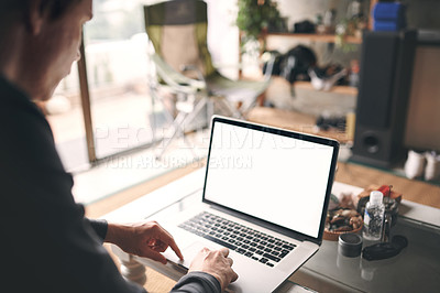 Buy stock photo Cropped shot of an unrecognisable man using a laptop at home