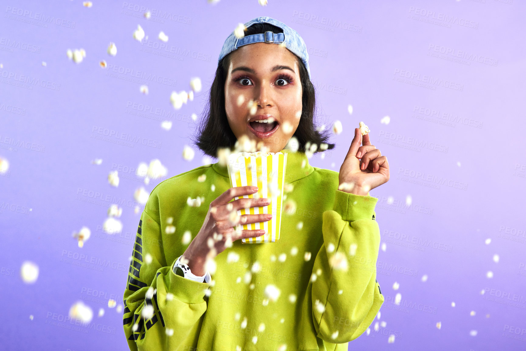 Buy stock photo Popcorn, movie and woman surprise watching theatre or streaming service or cinema and in studio against a purple background. Video, entertainment and film or television or omg and snack on mock up