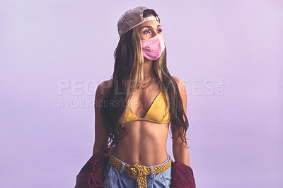 Buy stock photo Studio shot of a beautiful young woman wearing a face mask against a purple background