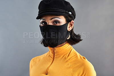 Buy stock photo Studio shot of a beautiful young woman wearing a face mask against a grey background