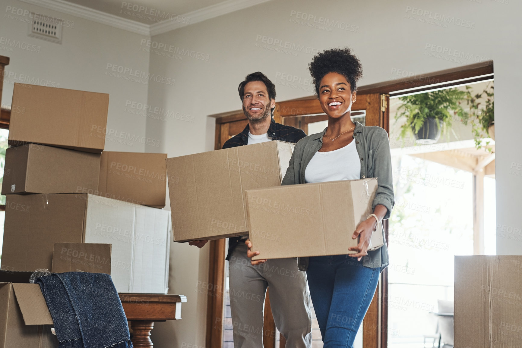 Buy stock photo Happy couple, real estate and moving in property with boxes for renovation, investment or relocation. Excited interracial man or woman owner carrying box in move together or mortgage loan in new home