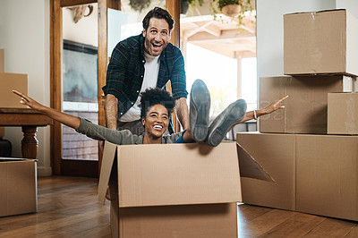 Buy stock photo Happy couple, box and real estate in new home or property for renovation and investment together. Excited interracial man, woman and playing in boxes, moving to house or celebration of fun relocation