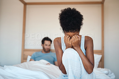 Buy stock photo Woman crying after fighting with husband in bedroom at home. Wife sad after husbands affair, lies and cheating in the bed. Depressed couple having relationship problems and decide to get a divorce