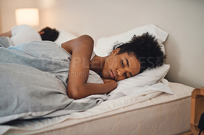Buy stock photo Sad, bad sleep and insomnia of a woman having relationship issues at home. Upset female or couple in the bedroom after having an argument. Depressed lady in thought and conflict with her husband.