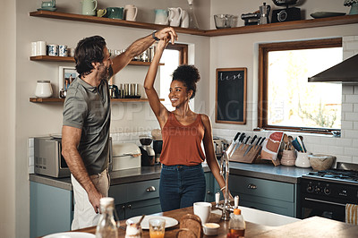 Buy stock photo Interracial couple, dance and love in kitchen for romance, fun bonding or holiday together at home. Happy man and woman dancing in joyful happiness for romantic relationship or enjoying weekend house