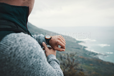 Buy stock photo Closeup shot of an unrecognisable man checking the time while out on a hike