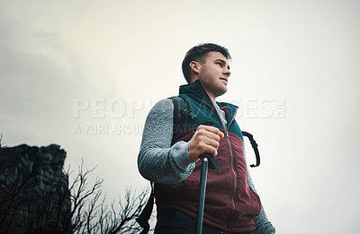 Buy stock photo Walking stick, hiking and man with nature, travel or wellness with exercise, recreation or hobby. Healthy person, tourism or hiker with activity, adventure or journey with pole, cloudy or environment