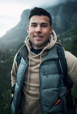 Buy stock photo Portrait of a young man hiking through the mountains