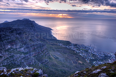 Buy stock photo Beautiful landscape of an iconic landmark and famous travel or vacation destination in South Africa at sunset. Aerial view of the sea, Table Mountain and a city on a cloudy evening with copy space