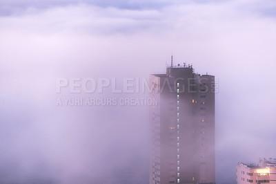 Buy stock photo Aerial view of fog or mist covering city building and skyscraper tower downtown in the early morning with copy space. Cold weather front, wildfire or bush fire smoke rolling into town in South Africa