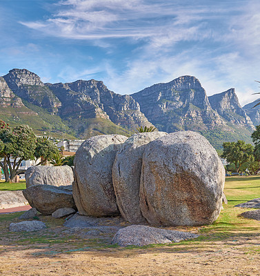 Buy stock photo Landscape view of mountains beach rocks in famous travel or tourism destination with lush trees and grass. Scenic Twelve Apostles with blue sky and clouds in Camps Bay, Cape Town, South Africa