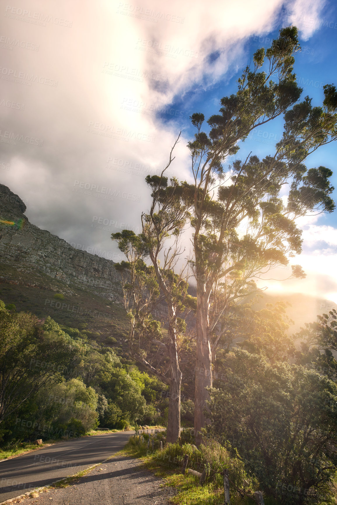 Buy stock photo Scenic landscape view of Table Mountain National Park, Cape Town in South Africa. Beautiful scenery of a natural environment, roads, and the street against a cloudy blue sky in a popular tourist city