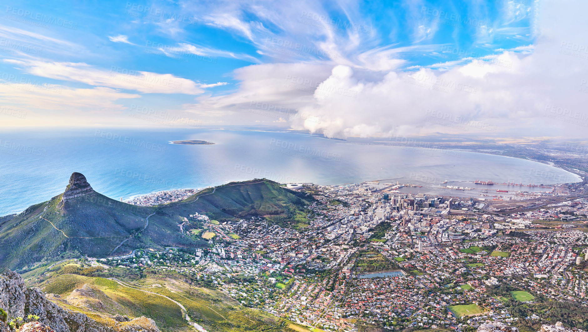 Buy stock photo Copyspace landscape view of Lion's Head and surroundings during the day in summer from above. Aerial view of the beautiful city of Cape Town with popular natural landmarks against a cloudy blu sky