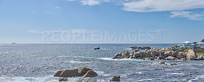 Buy stock photo Rocky ocean coast on sunny summer day with blue skies and clear blue water, outside in nature. Serene and calm sea allows for relaxing or swimming. Ocean is found in the Western Cape of South Africa