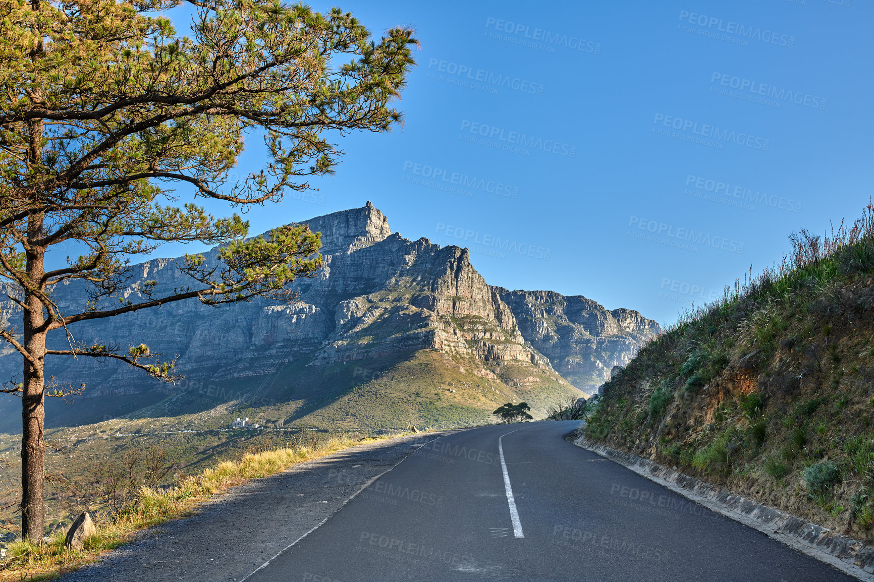 Buy stock photo Empty road on the mountain at sunrise. Empty street overlooking mountain peak. Scenic view of the city from a street on the mountain at sunset. Landscape of a beautiful view of a city from a street