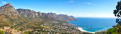 Buy stock photo Beautiful coastal landscape with mountains surrounded an urban city in a popular tourism destination. Aerial view of Cape Town city with Mountain outcrops and the ocean on a blue sky with copy space