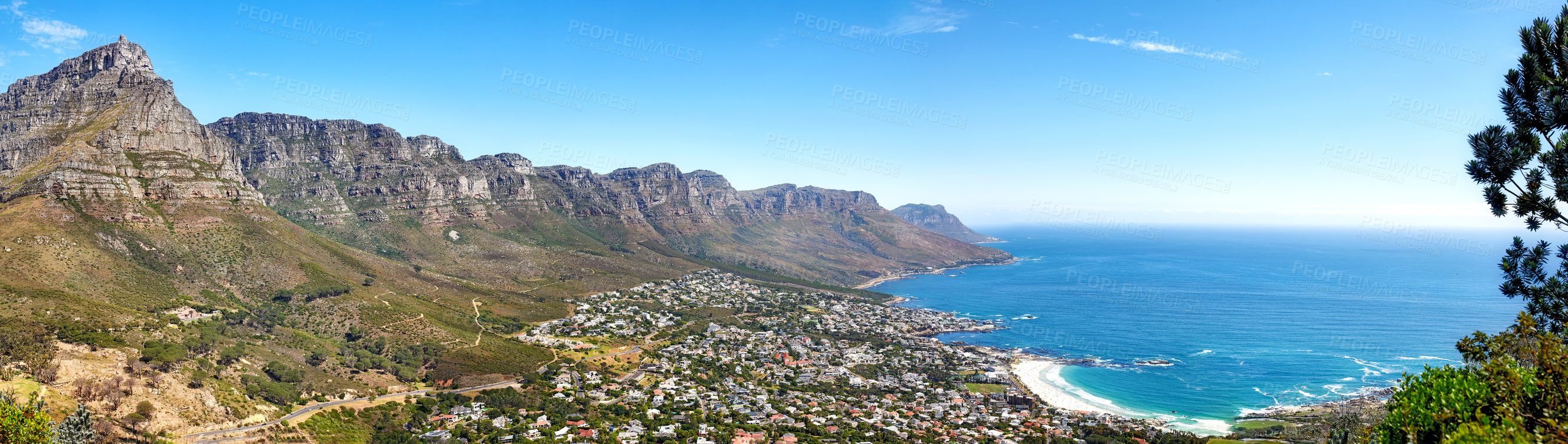 Buy stock photo Beautiful coastal landscape with mountains surrounded an urban city in a popular tourism destination. Aerial view of Cape Town city with Mountain outcrops and the ocean on a blue sky with copy space