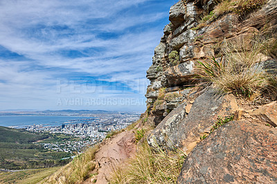 Buy stock photo Copyspace landscape view of mountain trails on Lion's Head, Table Mountain National Park in Cape Town, South Africa. Natural landmark for hiking and fitness walks against a cloudy blue sky in summer