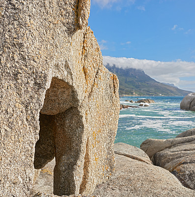 Buy stock photo Landscape of rocks and the ocean in Camps Bay, Cape Town, South Africa. Scenic view of big rocks on the shoreline of the beach in summer. Large stones in the sea at famous tourist destination
