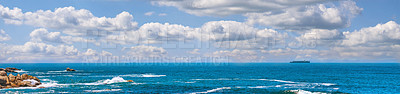 Buy stock photo Landscape banner of a scenic ocean view in Camps Bay, Cape Town in South Africa. Panoramic scenery of the beach and waves rolling in from the sea against a blue cloudy sky in summer
